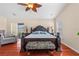 Primary bedroom featuring hardwood floors, a vaulted ceiling, and a large bed at 1606 Burryport Dr, Orlando, FL 32837