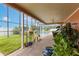 View of a screened patio with lush greenery and a pool in the background at 1606 Burryport Dr, Orlando, FL 32837