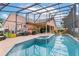 A screened-in pool and spa, with lounge seating, offering an outdoor relaxation area in a private backyard setting at 1606 Burryport Dr, Orlando, FL 32837