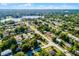 Panoramic aerial shot capturing a neighborhood with tree coverage and a glimpse of the lake at 1649 Weybridge St, Deltona, FL 32725