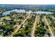 An aerial view of a leafy residential area near multiple lakes, featuring well-spaced homes and streets at 1649 Weybridge St, Deltona, FL 32725