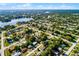 High-angle view of a neighborhood near a lake, boasting mature trees and a mix of home styles at 1649 Weybridge St, Deltona, FL 32725