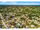Extensive aerial of single-Gathering homes interspersed with mature trees and well-manicured lawns in a lakeside neighborhood at 1649 Weybridge St, Deltona, FL 32725
