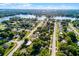An aerial perspective of a neighborhood close to the lake, surrounded by greenery and residential streets at 1649 Weybridge St, Deltona, FL 32725