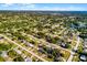 Lakeside neighborhood aerial showing mature trees, single Gathering homes, well-maintained lawns, and community swimming pools at 1649 Weybridge St, Deltona, FL 32725