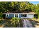 Birds eye view of a cozy one-story home with a screened porch, garage, tidy front yard and patterned concrete driveway at 1649 Weybridge St, Deltona, FL 32725
