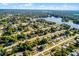 High aerial view displaying a lush, green neighborhood dotted with homes and connected by tidy streets at 1649 Weybridge St, Deltona, FL 32725