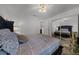 This main bedroom features a large bed, neutral walls, and hardwood floors at 1649 Weybridge St, Deltona, FL 32725