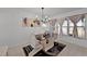 Bright dining room featuring a modern black dining table, white chairs, and stylish light fixture at 1649 Weybridge St, Deltona, FL 32725