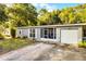 Charming single-story home featuring a screened porch, garage and a tidy front yard with a concrete tile driveway at 1649 Weybridge St, Deltona, FL 32725