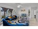 Stylish living room featuring plush blue sofas, modern decor, a ceiling fan, and bright natural light at 1649 Weybridge St, Deltona, FL 32725