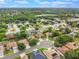 Wide aerial shot showcasing the neighborhood's layout, surrounding greenery, and distant lake at 165 Fig Tree Run, Longwood, FL 32750