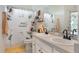 Bright bathroom features a sunflower shower curtain, dual sinks, and a large mirror at 165 Fig Tree Run, Longwood, FL 32750