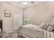 Comfortable bedroom with neutral decor, soft bedding, a window for natural light and ceiling fan at 165 Fig Tree Run, Longwood, FL 32750