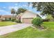 Well-maintained home with a wide driveway, two-car garage, and neatly trimmed landscaping at 165 Fig Tree Run, Longwood, FL 32750
