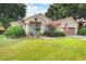 Inviting home featuring well-kept landscaping, decorative accents, and a cozy front porch at 165 Fig Tree Run, Longwood, FL 32750