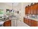Kitchen showcasing granite counters, stainless appliances and wood cabinets at 165 Fig Tree Run, Longwood, FL 32750