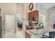 Kitchen displaying granite counters, stainless appliances, wood cabinets and bar seating at 165 Fig Tree Run, Longwood, FL 32750