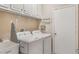 Efficient laundry room features overhead cabinets, utility sink, and modern washer and dryer at 165 Fig Tree Run, Longwood, FL 32750
