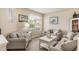 Cozy living room with comfortable seating, neutral decor, and natural light, perfect for relaxing at 165 Fig Tree Run, Longwood, FL 32750