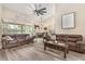 Open-concept living room with hardwood floors, view to lanai, kitchen and dining areas at 165 Fig Tree Run, Longwood, FL 32750