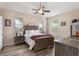 Comfortable main bedroom with ceiling fan, natural light and wood-look floors at 165 Fig Tree Run, Longwood, FL 32750