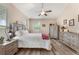 Inviting main bedroom with ceiling fan, natural light, and wood-look floors at 165 Fig Tree Run, Longwood, FL 32750