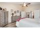 Main bedroom featuring wood-look floors, ceiling fan, and ensuite bathroom access at 165 Fig Tree Run, Longwood, FL 32750
