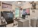 Large office with American flag, animal decor, work space, safe, and natural light from window at 165 Fig Tree Run, Longwood, FL 32750