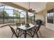 Relaxing screened patio featuring a dining table and ceiling fan, with a view of the pool at 165 Fig Tree Run, Longwood, FL 32750