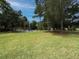 Well-maintained community playground on a large grassy field surrounded by mature trees at 165 Fig Tree Run, Longwood, FL 32750