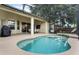 Relaxing backyard featuring a sparkling pool, covered patio, and ample seating at 165 Fig Tree Run, Longwood, FL 32750