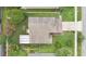 Overhead view of a single-Gathering home with a large backyard, driveway, and lush landscaping at 1916 Excalibur Dr, Orlando, FL 32822