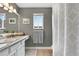 Well-lit bathroom with single vanity and a shower-tub combo behind a patterned shower curtain at 1916 Excalibur Dr, Orlando, FL 32822