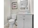 Clean half bathroom with a toilet and vanity against neutral paint and tile flooring at 1916 Excalibur Dr, Orlando, FL 32822