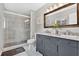 Modern bathroom with marble countertops, dual sinks, and a glass-enclosed shower with updated fixtures at 1916 Excalibur Dr, Orlando, FL 32822