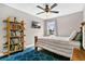 Simple bedroom with hardwood floors, ceiling fan, and shelving for books and media at 1916 Excalibur Dr, Orlando, FL 32822