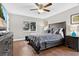 Comfortable bedroom with hardwood floors, ceiling fan, and a large window providing natural light at 1916 Excalibur Dr, Orlando, FL 32822
