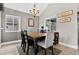 Charming dining room featuring neutral walls, a chandelier, and a wooden table with seating for six at 1916 Excalibur Dr, Orlando, FL 32822