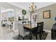 Cozy dining room featuring neutral walls, chandelier, wooden table with chairs and access to kitchen at 1916 Excalibur Dr, Orlando, FL 32822