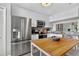 Well-lit kitchen with white cabinets, stainless steel appliances, and a center island for extra prep space at 1916 Excalibur Dr, Orlando, FL 32822