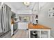Bright kitchen featuring stainless appliances, a center island, and white cabinetry with views into the living area at 1916 Excalibur Dr, Orlando, FL 32822