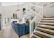 Bright living room featuring a fireplace, open staircase and large sectional sofa at 1916 Excalibur Dr, Orlando, FL 32822