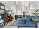 Bright living room with comfortable sectional, TV, shelving, and an open view into the kitchen at 1916 Excalibur Dr, Orlando, FL 32822