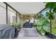 This covered patio offers extra space, comfortable seating, and backyard views at 1916 Excalibur Dr, Orlando, FL 32822