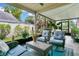 This covered patio offers comfortable seating and lush plants for an outdoor living space at 1916 Excalibur Dr, Orlando, FL 32822
