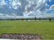 Expansive backyard view overlooking a serene pond and neighborhood homes at 228 Aquamarine Ln, Kissimmee, FL 34758