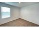 Neutral bedroom featuring a window with blinds and carpeted flooring at 228 Aquamarine Ln, Kissimmee, FL 34758