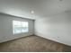 This is a comfortable bedroom that features carpet and a window, providing natural light at 228 Aquamarine Ln, Kissimmee, FL 34758