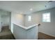 Upstairs hallway with carpet, a window, and white walls at 228 Aquamarine Ln, Kissimmee, FL 34758
